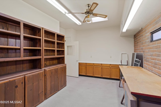 6891 N Camino Verde, Tucson, AZ 85743 - interior space featuring brick wall, ceiling fan, and finished concrete flooring