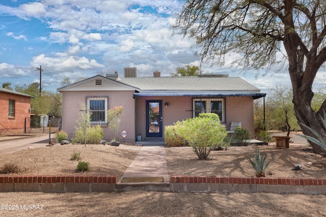 1700 E Water St, Tucson, AZ 85719 - view of front of house featuring covered porch, central AC, and a chimney