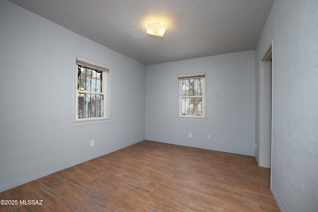 1700 E Water St, Tucson, AZ 85719 - empty room with healthy amount of natural light and light wood-style floors