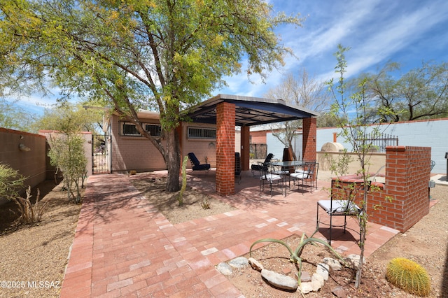 1700 E Water St, Tucson, AZ 85719 - view of patio / terrace featuring a gazebo, a gate, and outdoor dining space