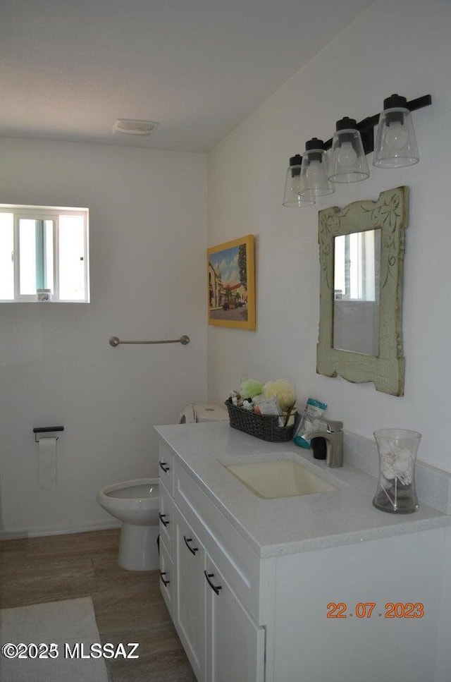 1700 E Water St, Tucson, AZ 85719 - bathroom with vanity, toilet, and wood finished floors