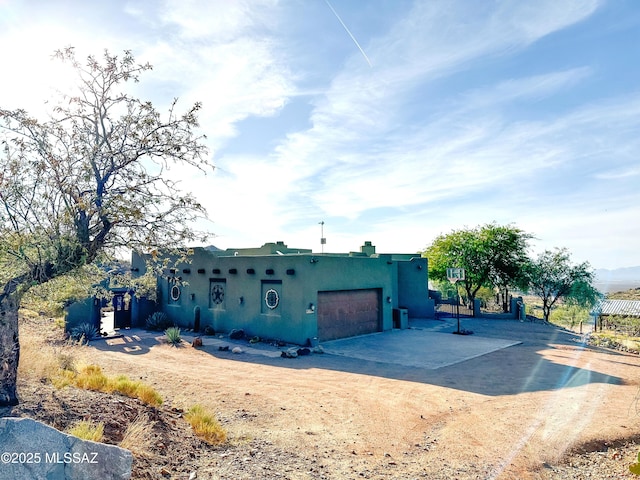 17950 S Via El Caballo Prieto, Vail, AZ 85641 - adobe home featuring a garage, stucco siding, and dirt driveway