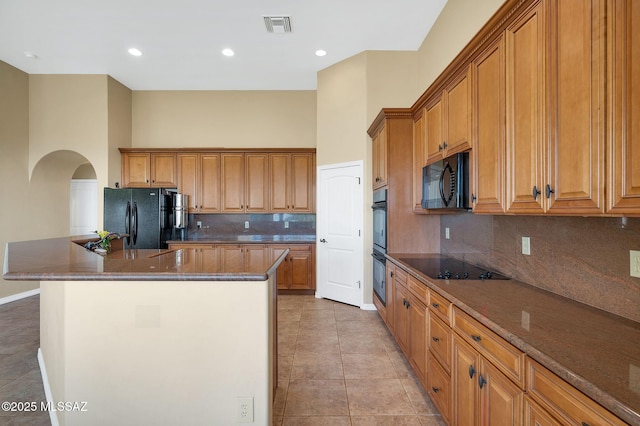 17950 S Via El Caballo Prieto, Vail, AZ 85641 - kitchen featuring black appliances, arched walkways, a kitchen island, tasteful backsplash, and light tile patterned floors