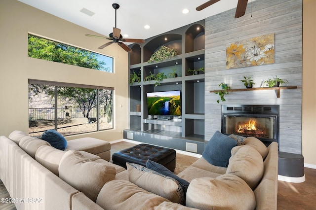 17950 S Via El Caballo Prieto, Vail, AZ 85641 - living area with a ceiling fan, baseboards, a high ceiling, built in features, and a large fireplace