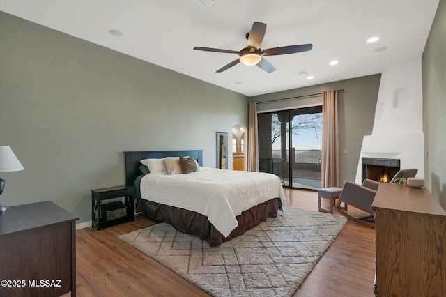 17950 S Via El Caballo Prieto, Vail, AZ 85641 - bedroom featuring access to exterior, wood finished floors, a large fireplace, ceiling fan, and recessed lighting