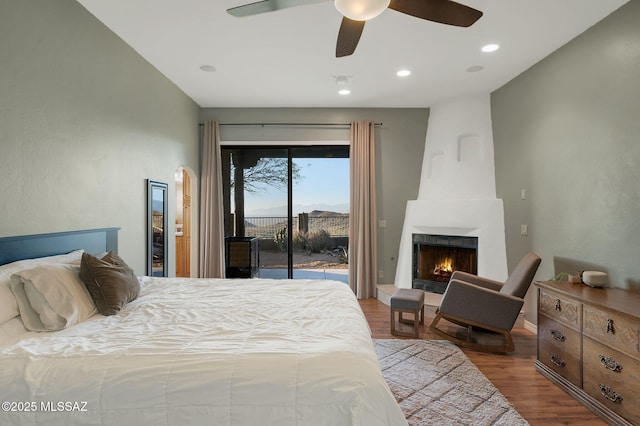 17950 S Via El Caballo Prieto, Vail, AZ 85641 - bedroom with access to exterior, wood finished floors, a fireplace, a ceiling fan, and recessed lighting