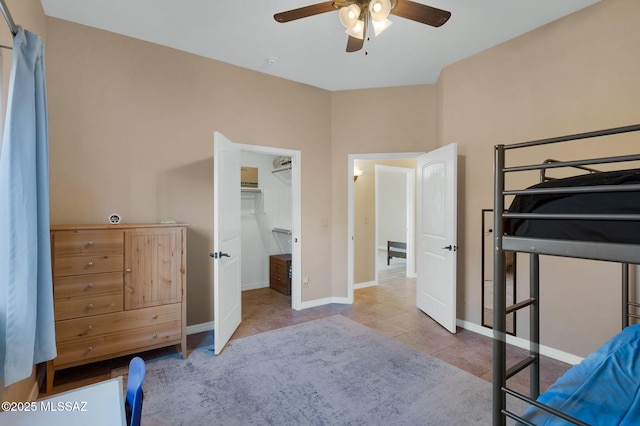 17950 S Via El Caballo Prieto, Vail, AZ 85641 - tiled bedroom featuring baseboards, a walk in closet, and a ceiling fan