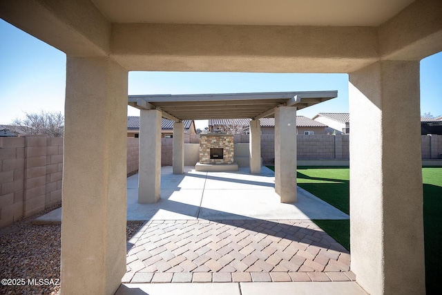 37 W Corte Perla Fina, Sahuarita, AZ 85629 - view of patio featuring a fenced backyard and an outdoor stone fireplace