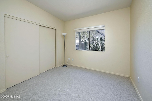 4640 E Via Pimeria Alta, Tucson, AZ 85718 - unfurnished bedroom featuring carpet, a closet, and baseboards