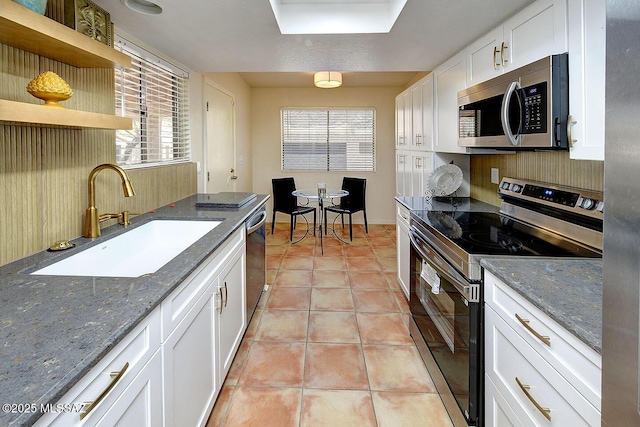 4640 E Via Pimeria Alta, Tucson, AZ 85718 - kitchen with appliances with stainless steel finishes, a sink, white cabinets, open shelves, and light tile patterned floors