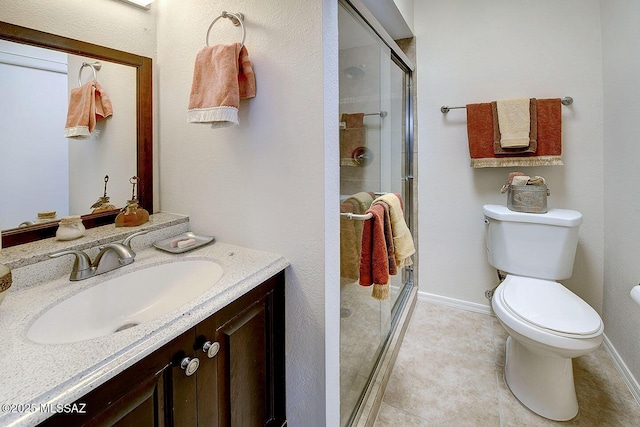 4640 E Via Pimeria Alta, Tucson, AZ 85718 - bathroom featuring vanity, toilet, a shower stall, tile patterned floors, and baseboards