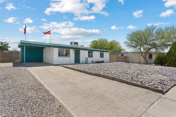 7634 E Apple Tree Dr, Tucson, AZ 85730 - ranch-style house with driveway, fence, and an attached carport