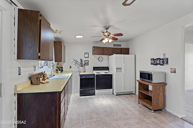 7634 E Apple Tree Dr, Tucson, AZ 85730 - kitchen with white appliances, a sink, light countertops, dark brown cabinets, and a ceiling fan