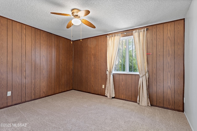7634 E Apple Tree Dr, Tucson, AZ 85730 - empty room with a textured ceiling, carpet, a ceiling fan, and wooden walls