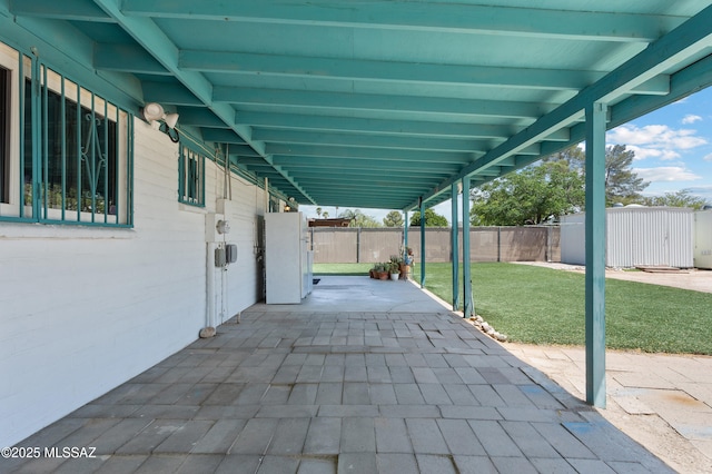 7634 E Apple Tree Dr, Tucson, AZ 85730 - view of patio / terrace with an outdoor structure and a storage unit