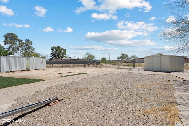 7634 E Apple Tree Dr, Tucson, AZ 85730 - view of yard with a storage unit, fence, and an outdoor structure
