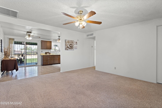 7634 E Apple Tree Dr, Tucson, AZ 85730 - living area with light colored carpet, ceiling fan, and a textured ceiling