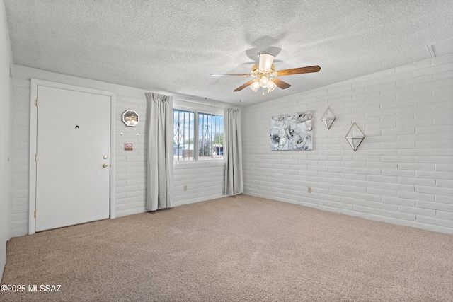 7634 E Apple Tree Dr, Tucson, AZ 85730 - entrance foyer featuring brick wall, ceiling fan, carpet, and a textured ceiling