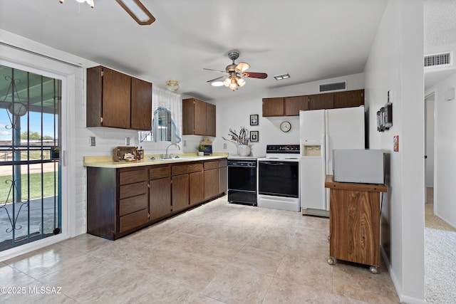 7634 E Apple Tree Dr, Tucson, AZ 85730 - kitchen featuring range with electric stovetop, dishwasher, a ceiling fan, and light countertops