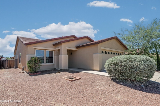 9410 E Grapevine Spring Pl, Tucson, AZ 85710 - single story home with stucco siding, a tiled roof, a garage, and fence