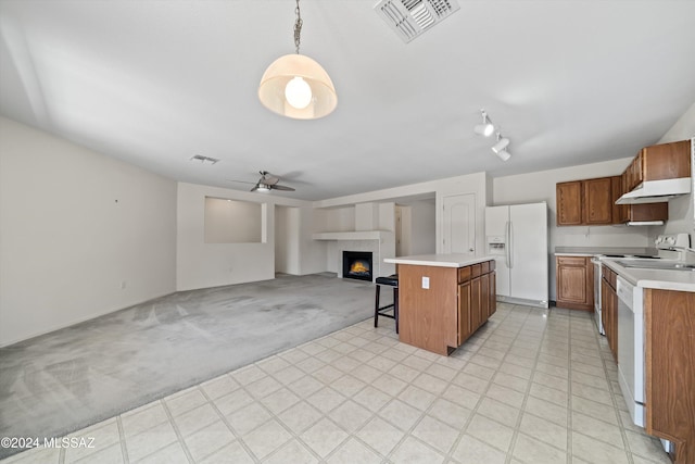 9410 E Grapevine Spring Pl, Tucson, AZ 85710 - kitchen featuring a tiled fireplace, open floor plan, visible vents, white appliances, and light countertops