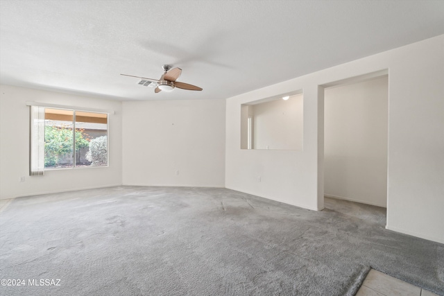9410 E Grapevine Spring Pl, Tucson, AZ 85710 - carpeted spare room with visible vents and ceiling fan
