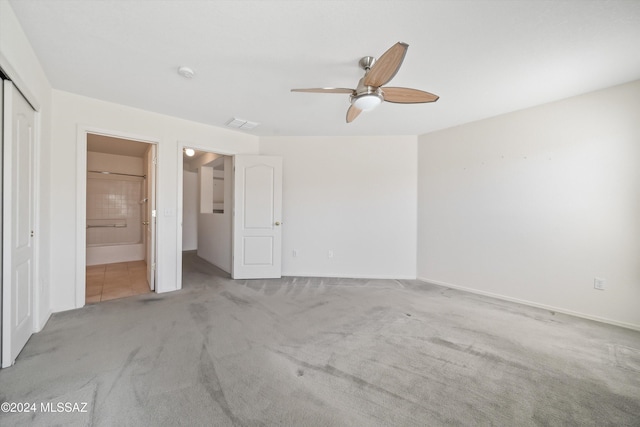 9410 E Grapevine Spring Pl, Tucson, AZ 85710 - unfurnished bedroom featuring ensuite bathroom, a closet, light colored carpet, a ceiling fan, and baseboards
