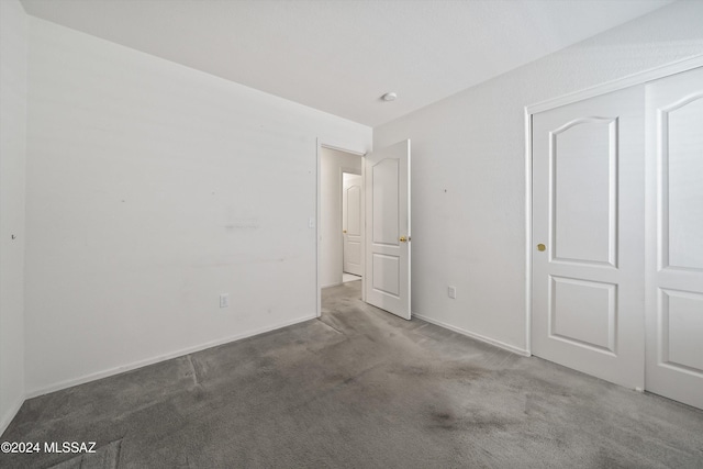 9410 E Grapevine Spring Pl, Tucson, AZ 85710 - unfurnished bedroom with baseboards and carpet floors