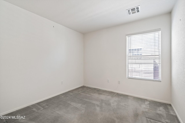 9410 E Grapevine Spring Pl, Tucson, AZ 85710 - carpeted empty room with a wealth of natural light, visible vents, and baseboards