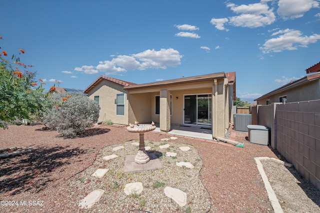 9410 E Grapevine Spring Pl, Tucson, AZ 85710 - back of house featuring cooling unit, stucco siding, fence, and a patio