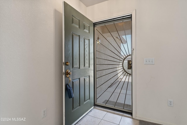 9410 E Grapevine Spring Pl, Tucson, AZ 85710 - doorway featuring baseboards and light tile patterned flooring