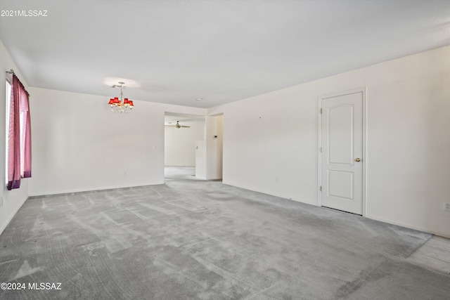 9410 E Grapevine Spring Pl, Tucson, AZ 85710 - spare room with baseboards, a chandelier, and carpet
