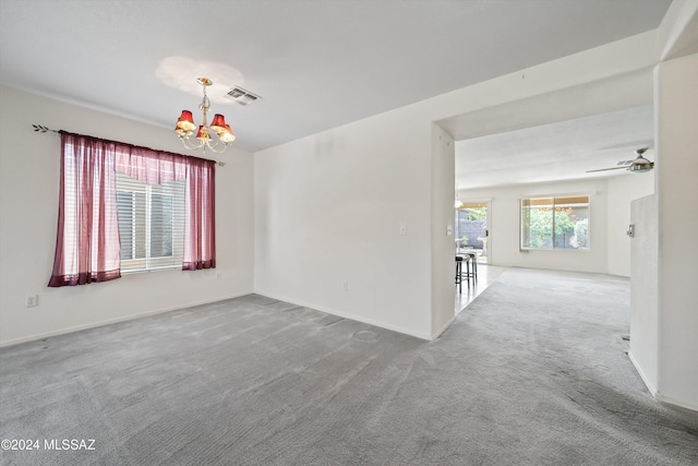 9410 E Grapevine Spring Pl, Tucson, AZ 85710 - empty room with baseboards, carpet flooring, visible vents, and ceiling fan with notable chandelier