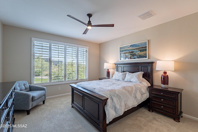 bedroom with light colored carpet, baseboards, and ceiling fan