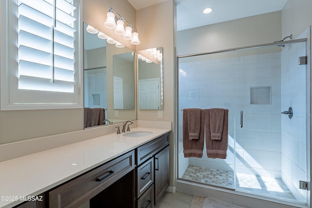 full bathroom with a shower stall and vanity
