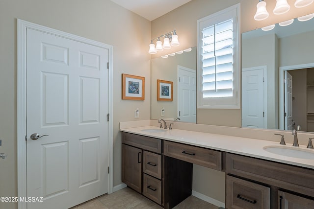 bathroom featuring double vanity, tile patterned floors, a closet, and baseboards