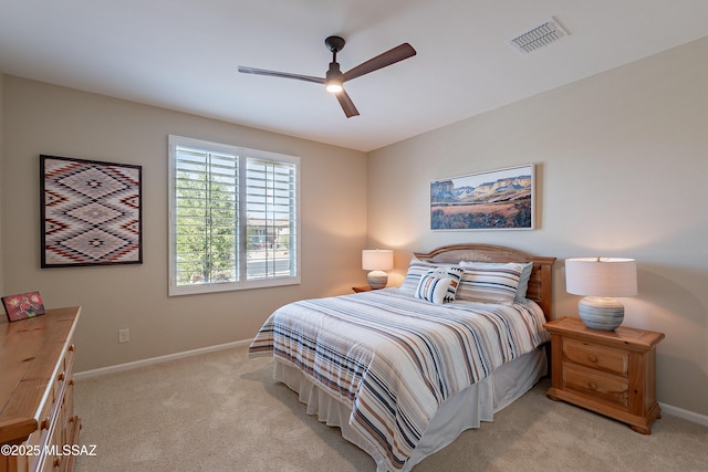 bedroom with light colored carpet, baseboards, and ceiling fan