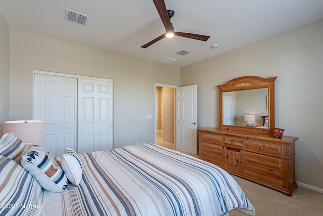 bedroom featuring light carpet, a closet, a ceiling fan, and baseboards