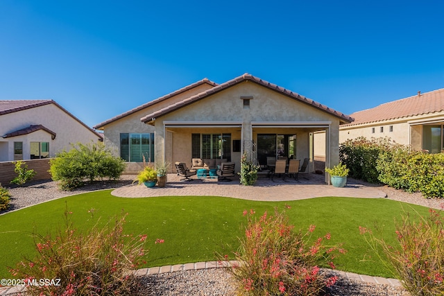 back of property featuring outdoor lounge area, a patio area, and stucco siding