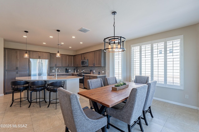 dining space featuring plenty of natural light, baseboards, recessed lighting, and a chandelier