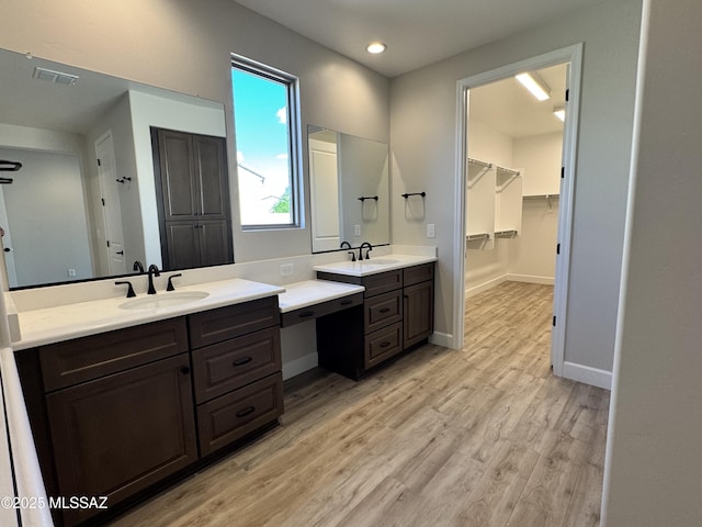61662 E Quartzite Rd, Oracle, AZ 85623 - full bath with wood finished floors, two vanities, baseboards, recessed lighting, and a walk in closet