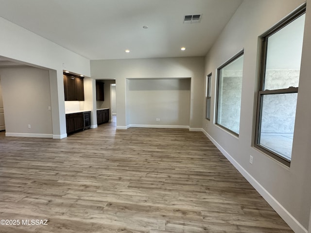 61662 E Quartzite Rd, Oracle, AZ 85623 - unfurnished living room featuring light wood-style floors, baseboards, and recessed lighting