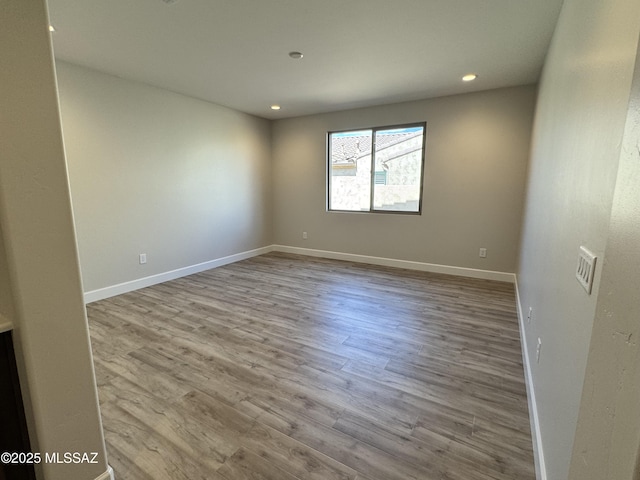 61662 E Quartzite Rd, Oracle, AZ 85623 - empty room with wood finished floors, recessed lighting, and baseboards