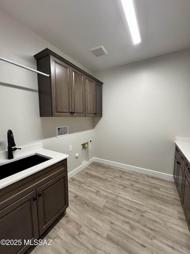 61662 E Quartzite Rd, Oracle, AZ 85623 - laundry room featuring hookup for a washing machine, cabinet space, hookup for a gas dryer, baseboards, and hookup for an electric dryer