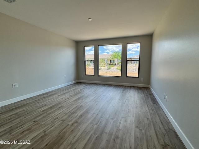 61662 E Quartzite Rd, Oracle, AZ 85623 - empty room featuring dark wood-style floors and baseboards