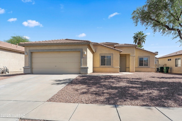 5523 W Carriage Dr, Tucson, AZ 85742 - view of front of property featuring stucco siding, a garage, a tile roof, and driveway