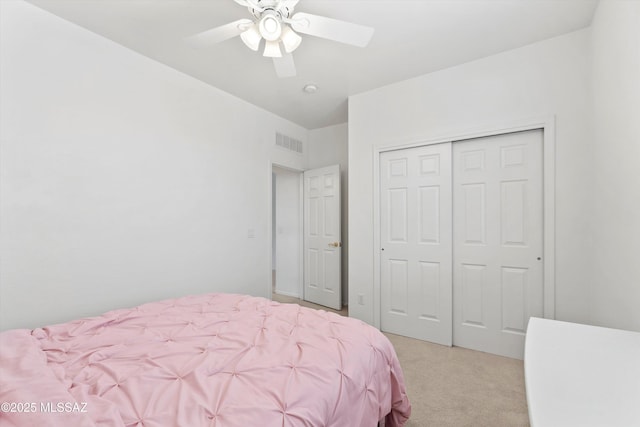 5523 W Carriage Dr, Tucson, AZ 85742 - bedroom featuring light carpet, a closet, and a ceiling fan
