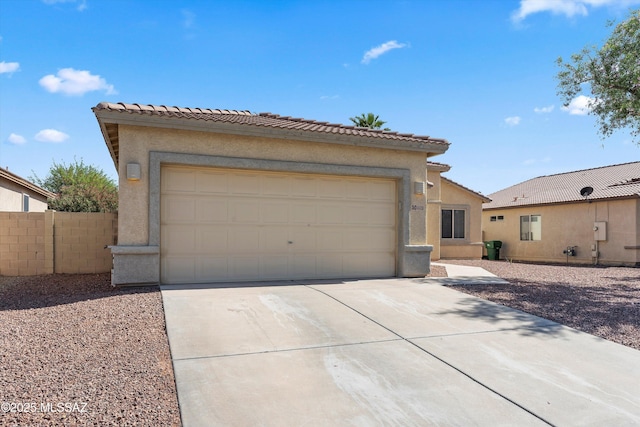 5523 W Carriage Dr, Tucson, AZ 85742 - view of front of house featuring stucco siding, concrete driveway, a tile roof, and a garage