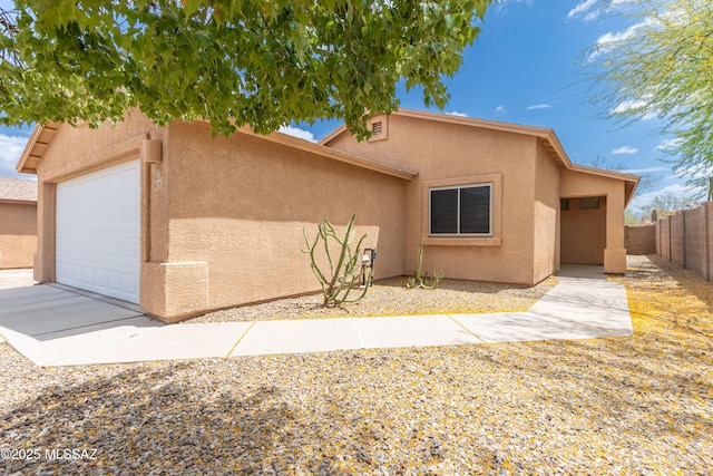 6591 S Avenida Santa Carolina, Tucson, AZ 85756 - view of front facade with stucco siding, fence, and a garage