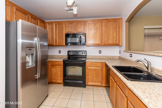 6591 S Avenida Santa Carolina, Tucson, AZ 85756 - kitchen with black appliances, a sink, light tile patterned floors, light countertops, and arched walkways